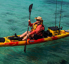 Person kayaking in ocean.
